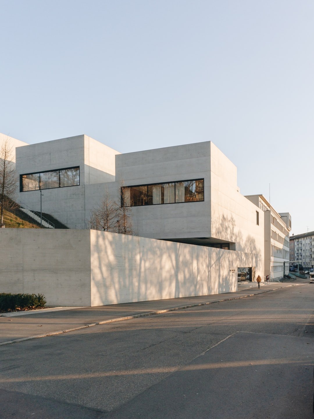 white concrete building near bare trees during daytime